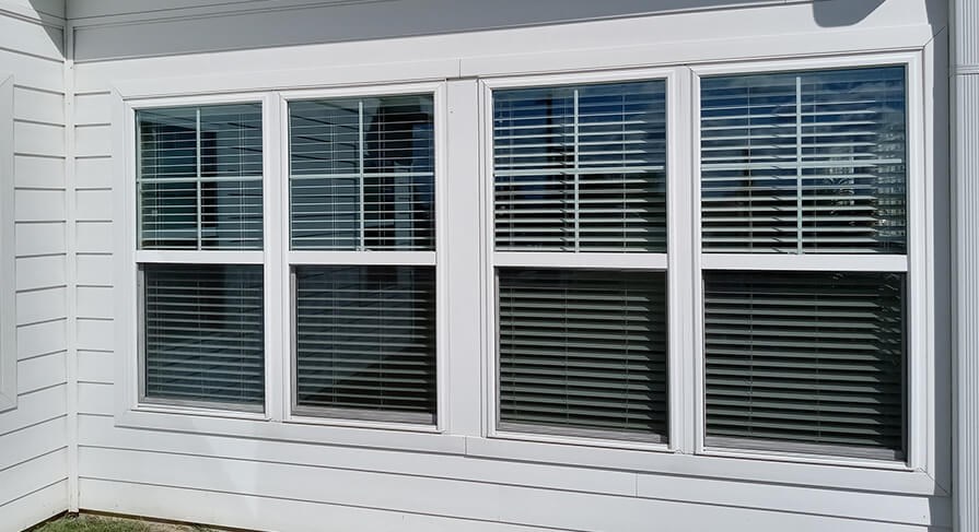 Double hung windows on the side of a residential home